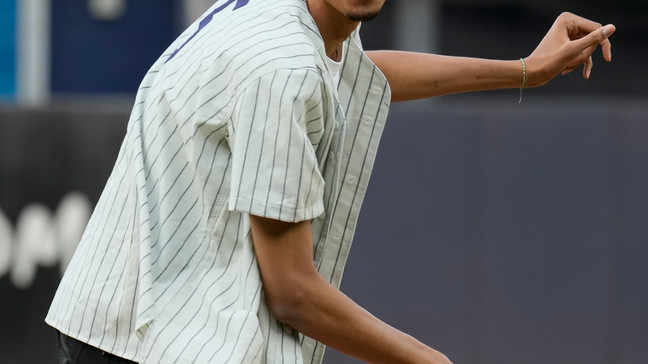 Victor Wembanyama, a projected first-round NBA draft pick, reacts after throwing the ceremonial first pitch before a baseball game between the New York Yankees and the Seattle Mariners, Tuesday, June 20, 2023, in New York. (AP Photo/John Minchillo)